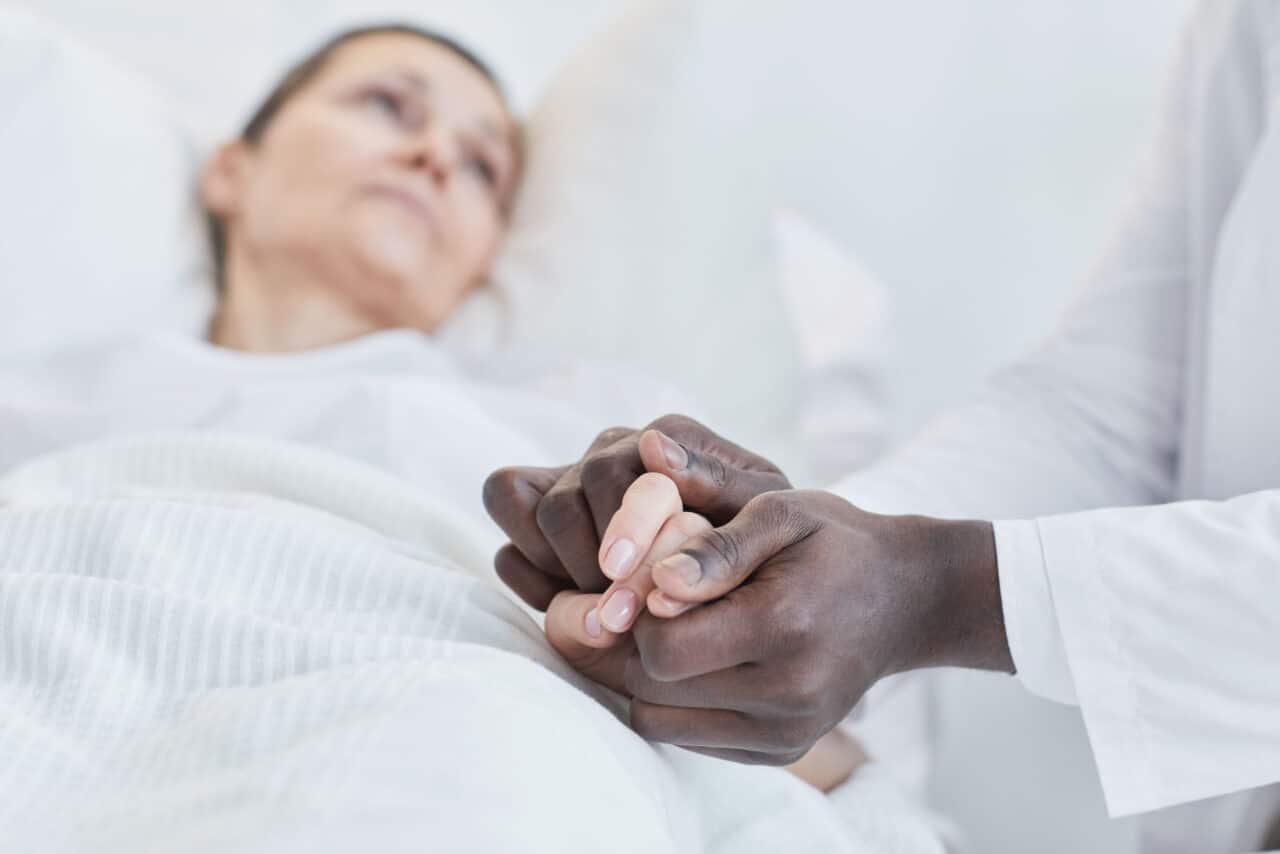 Husband And Wife Holding Hands At Death Bed
