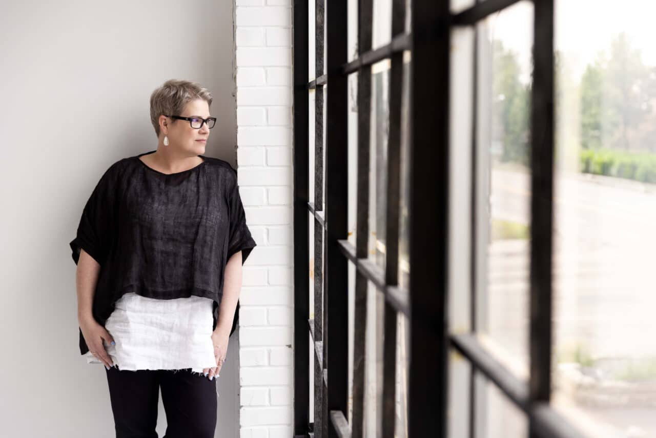 Woman inside a hospital looking out a window